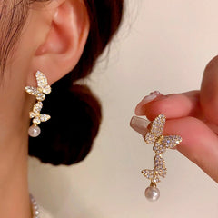 Angled view of the 14K Gold-Plated Zircon Butterfly Pearl Tassel Earrings