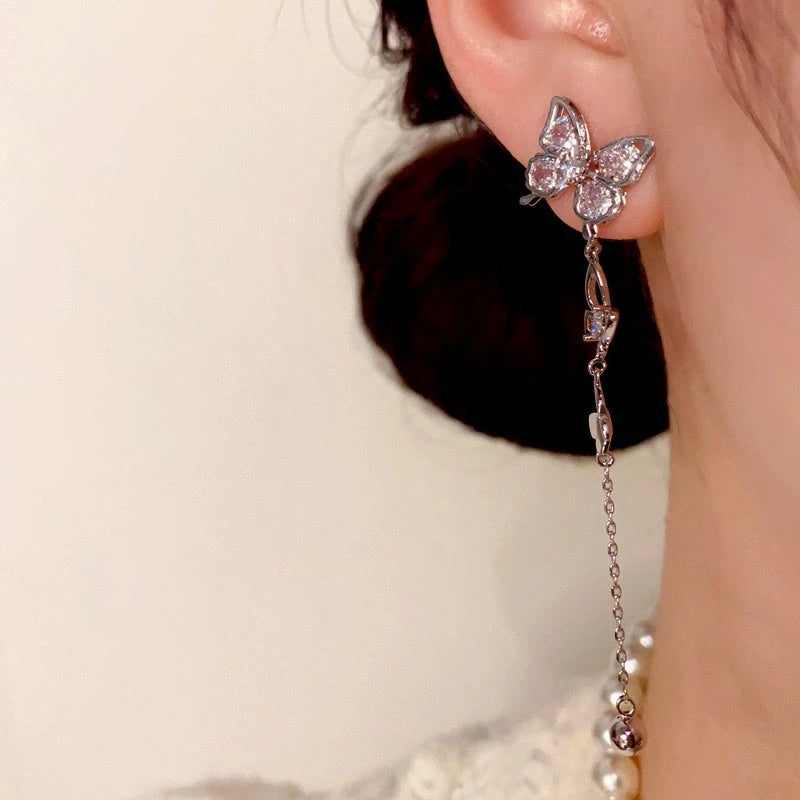 Angled view of the 14K Gold-Plated Zircon Butterfly Tassel Earrings