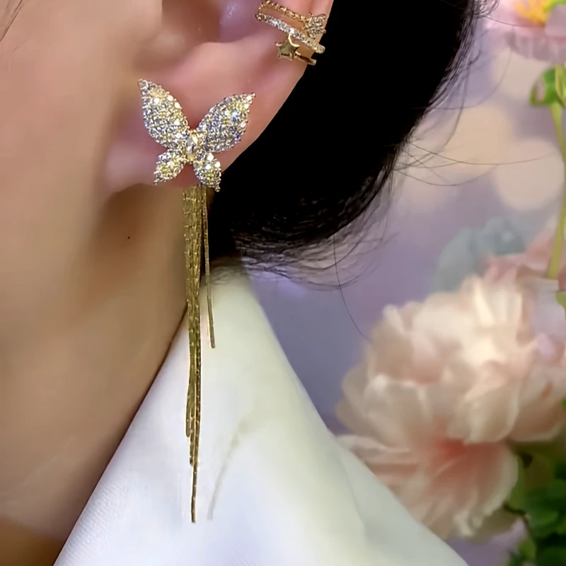 Model showcasing the dangle and style of the 14K Gold-Plated Zircon Butterfly Tassel Earrings