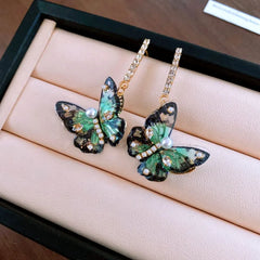 Close-up detail of the sparkling zircons and plating on the Green Butterfly Earrings