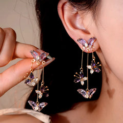 Angled view of the 14K Gold-Plated Zircon Butterfly Tassel Earrings