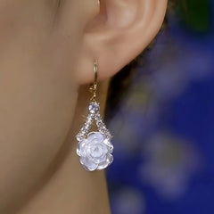 Model showcasing the dangle and style of the 14K Gold-Plated Zircon Camellia Earrings