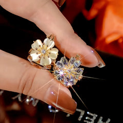 Angled view of the 14K Gold-Plated Zircon Cat's Eye Double-Sided Flower Earrings