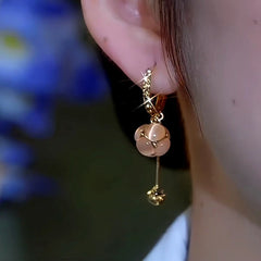 Close-up detail of the sparkling zircons and plating on the Cat's Eye Tassel Earrings