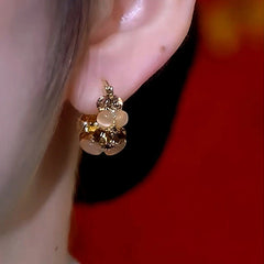 Model showcasing the dangle and style of the 14K Gold-Plated Zircon Cat's Eye Stone Basket Earrings
