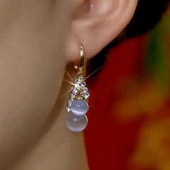 Close-up detail of the sparkling zircons and plating on the Cat's Eye Drop Earrings