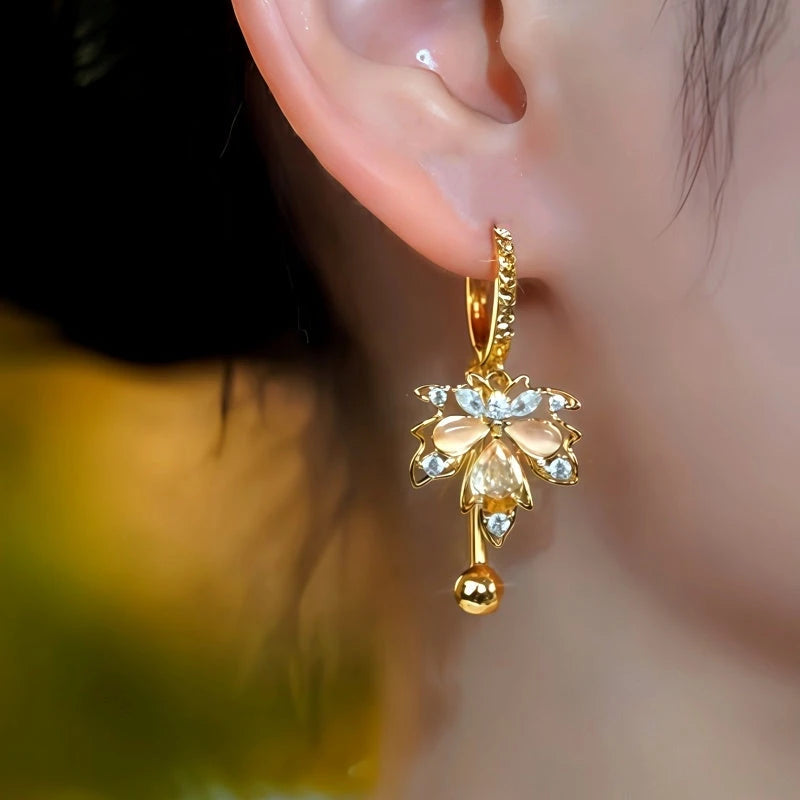 Close-up detail of the sparkling zircons and plating on the Champagne Maple Leaf Earrings