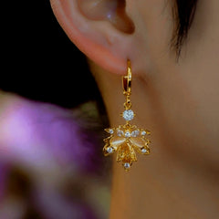 Close-up detail of the sparkling zircons and plating on the Gold Maple Leaf Earrings