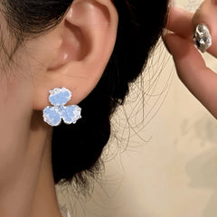Model showcasing the dangle and style of the 14K Gold-Plated Zircon Crystal Flower Earrings