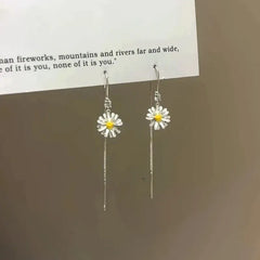 Model showcasing the dangle and style of the 14K Gold-Plated Zircon Daisy Flower Threader Earrings