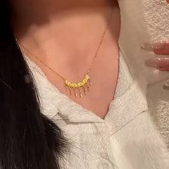 Detailed view of the 14K Gold-Plated Zircon Diamond-Studded Crescent Tassel Necklace chain and pendant