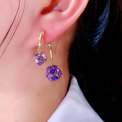 Close-up detail of the sparkling zircons and plating on the Purple Ball Earrings