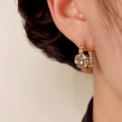Angled view of the 14K Gold-Plated Zircon Diamond Ball Hoop Earrings