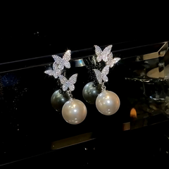 Angled view of the 14K Gold-Plated Zircon Diamond Butterfly Tassel Earrings