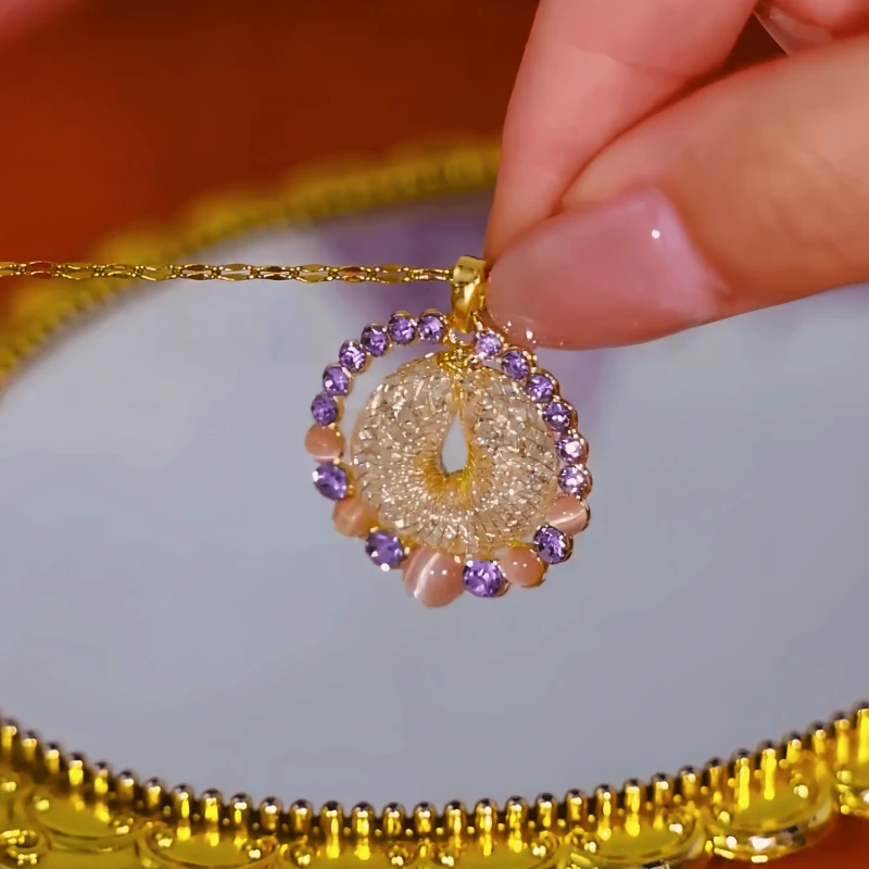 Close-up of the pendant and clasp on the Hoop Pendant Necklace