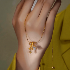 Close-up of the pendant and clasp on the Gold Cross Necklace