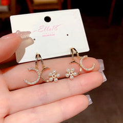Model showcasing the dangle and style of the 14K Gold-Plated Zircon Diamond Double-C Flower Pearl Earrings