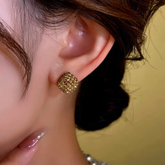 Model showcasing the dangle and style of the 14K Gold-Plated Zircon Diamond Earrings