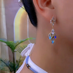 Model showcasing the dangle and style of the 14K Gold-Plated Zircon Diamond Earrings