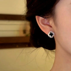 Close-up detail of the sparkling zircons and plating on the Black Clover Studs