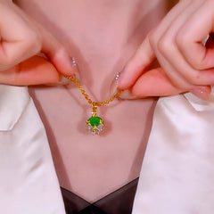 Detailed view of the 14K Gold-Plated Zircon Diamond Green Cat's Eye Stone Ball Pendant Necklace chain and pendant