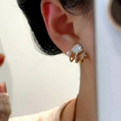 Model showcasing the dangle and style of the 14K Gold-Plated Zircon Diamond Multi-Layer Claw Star Bead Stud Earrings