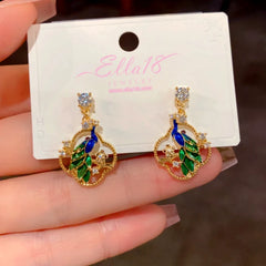 Model showcasing the dangle and style of the 14K Gold-Plated Zircon Diamond Peacock Earrings