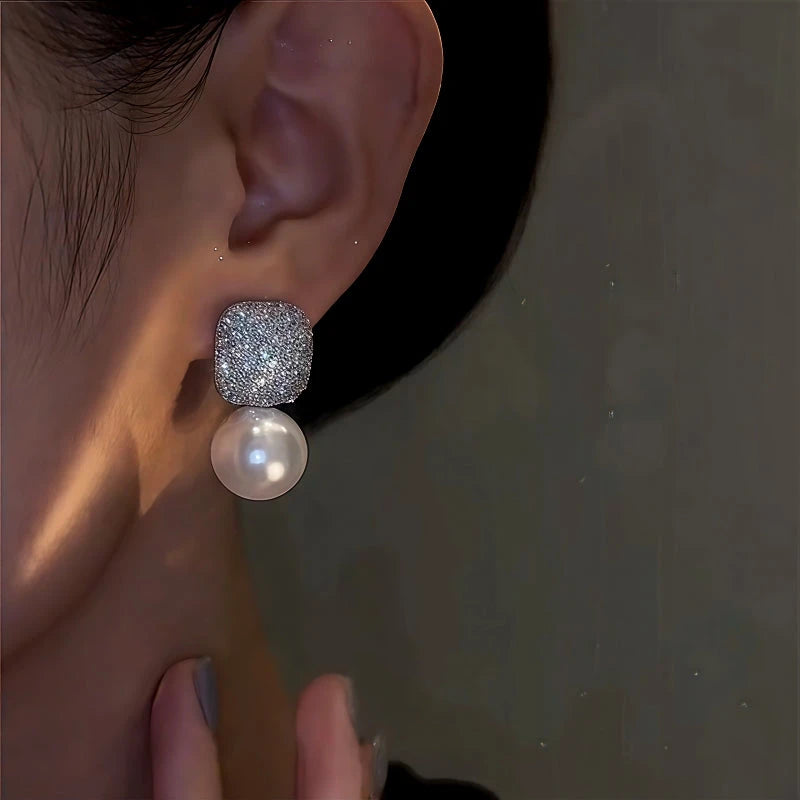 Close-up detail of the sparkling zircons and plating on the White Pearl Earrings