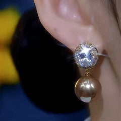 Model showcasing the dangle and style of the 14K Gold-Plated Zircon Diamond Pearl Earrings