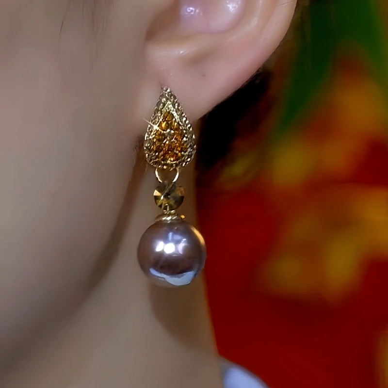 Model showcasing the dangle and style of the 14K Gold-Plated Zircon Diamond Pearl Earrings