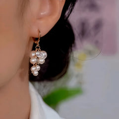 Close-up detail of the sparkling zircons and plating on the Gold Tassel Earrings
