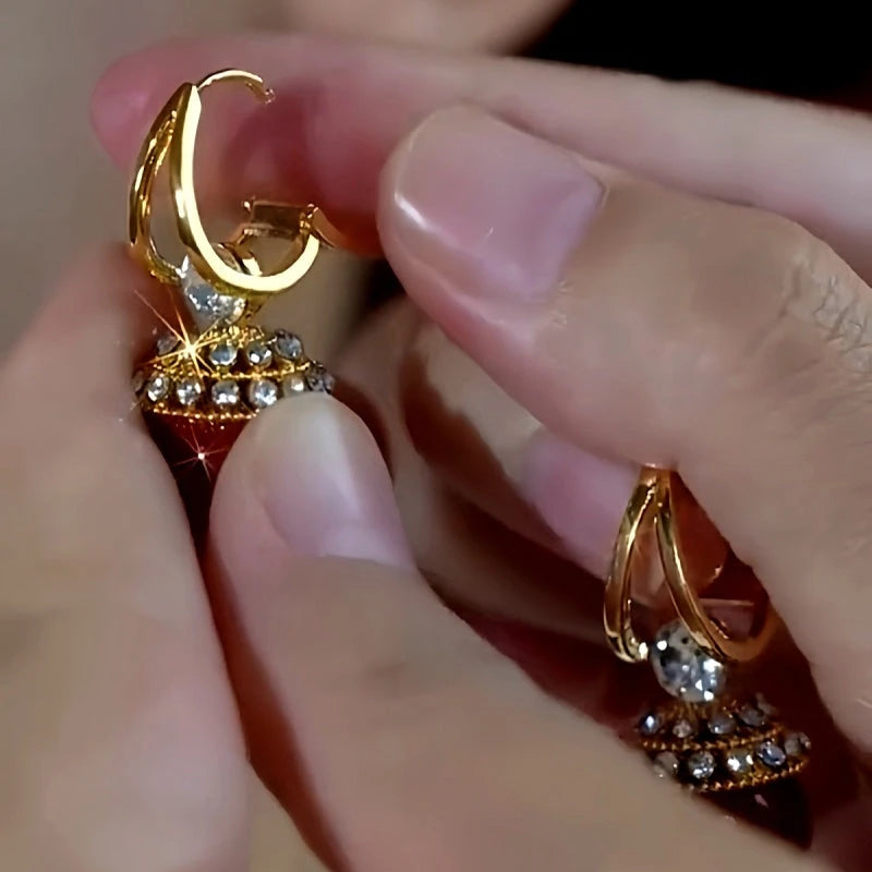 Model showcasing the dangle and style of the 14K Gold-Plated Zircon Diamond Red Pearl Earrings