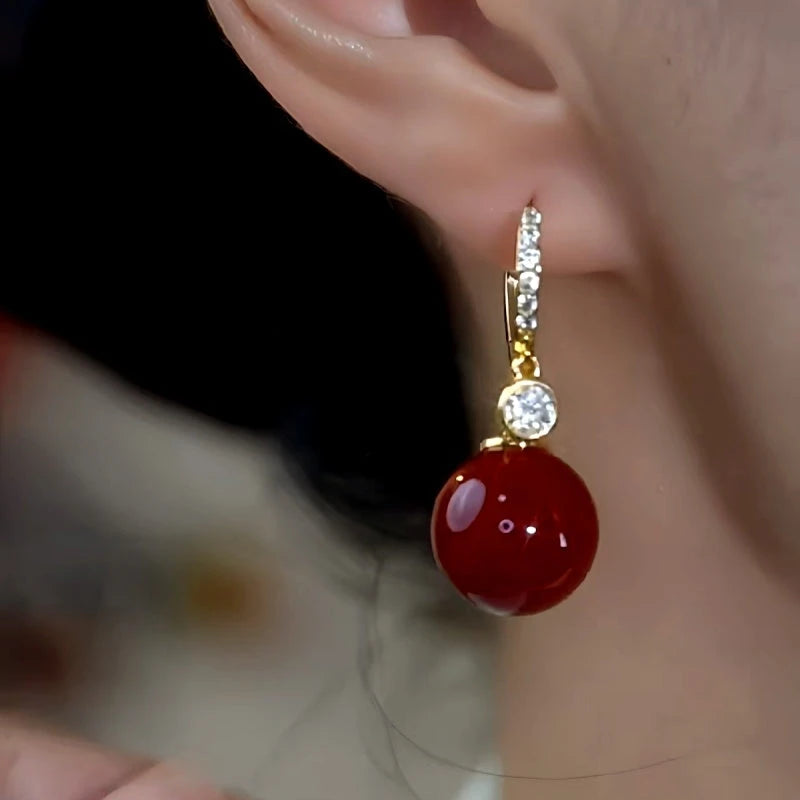 Close-up detail of the sparkling zircons and plating on the Red Pearl Earrings