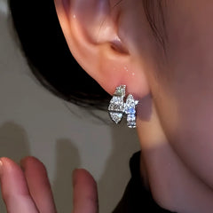 Model showcasing the dangle and style of the 14K Gold-Plated Zircon Diamond Snake-Shaped Earrings