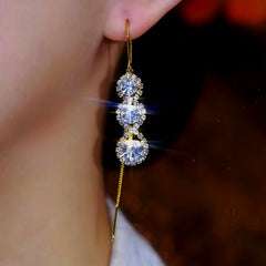 Model showcasing the dangle and style of the 14K Gold-Plated Zircon Diamond Tassel Threader Earrings