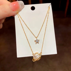 Close-up of the pendant and clasp on the Star & Moon Necklace