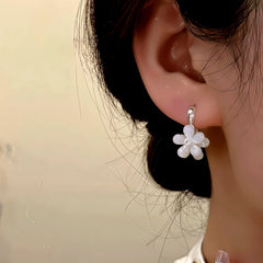 Close-up detail of the sparkling zircons and plating on the Double-Sided Flower Earrings