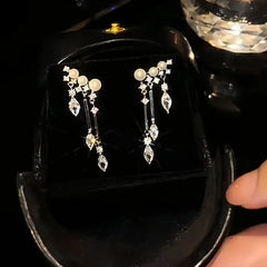 Angled view of the 14K Gold-Plated Zircon Drop Pearl Tassel Earrings