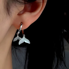 Close-up detail of the sparkling zircons and plating on the Fishtail Cross Earrings