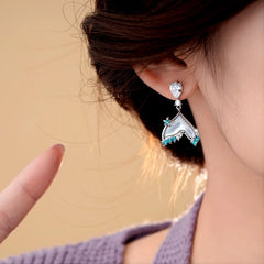 Model showcasing the dangle and style of the 14K Gold-Plated Zircon Fishtail Tassel Earrings