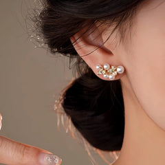 Model showcasing the dangle and style of the 14K Gold-Plated Zircon Flower Bead Stud Earrings