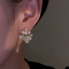 Model showcasing the dangle and style of the 14K Gold-Plated Zircon Flower Earrings