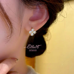 Model showcasing the dangle and style of the 14K Gold-Plated Zircon Flower Hoop Earrings