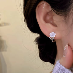 Close-up detail of the sparkling zircons and plating on the Dangling Flower Hoops