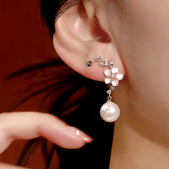 Model showcasing the dangle and style of the 14K Gold-Plated Zircon Flower Pearl Earrings