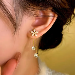 Model showcasing the dangle and style of the 14K Gold-Plated Zircon Flower Tassel Earrings