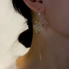 Angled view of the 14K Gold-Plated Zircon Flower Threader Earrings