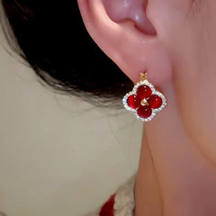 Model showcasing the dangle and style of the 14K Gold-Plated Zircon Four-Leaf Flower Earrings