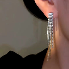 Model showcasing the dangle and style of the 14K Gold-Plated Zircon Front And Back Tassel Earrings