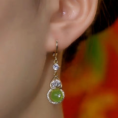 Model showcasing the dangle and style of the 14K Gold-Plated Zircon Gourd Earrings